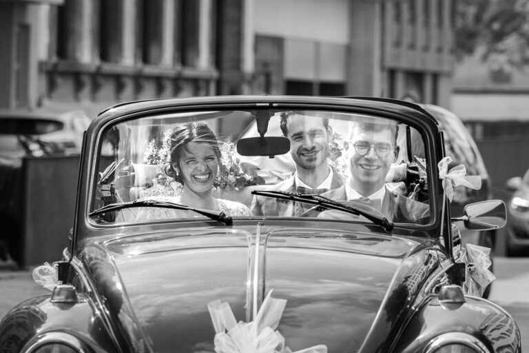 Michelle en Kevin, het huwelijkskoppel waarvoor ik de huwelijksreportage maakte, in een open VW cabrio kever